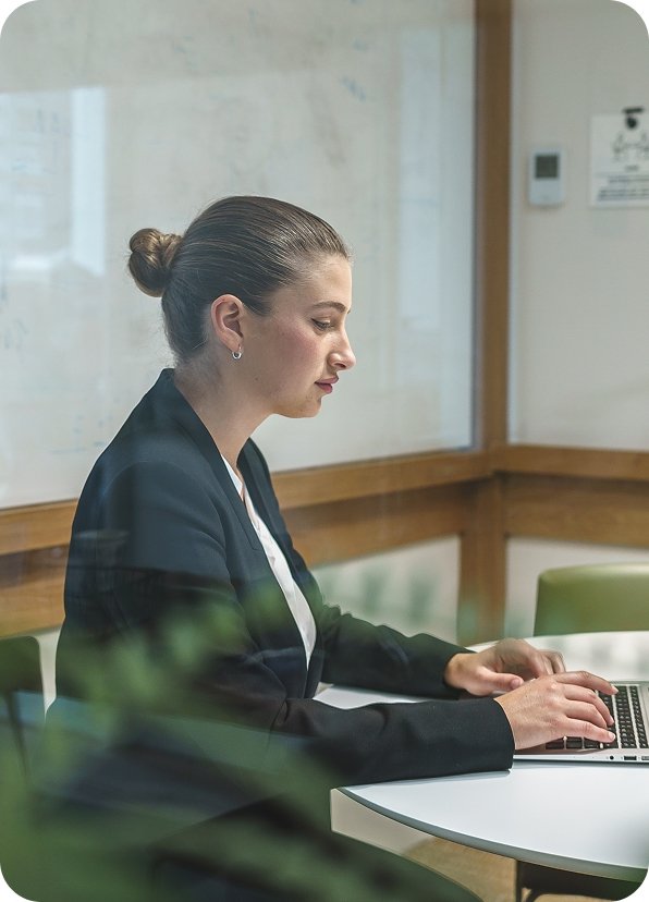 Woman working in office on laptop